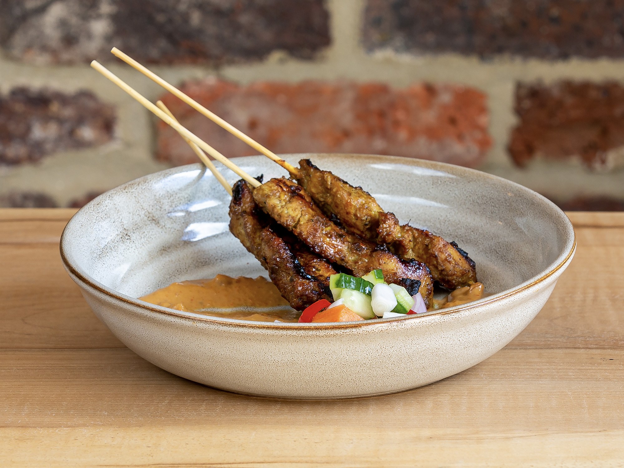 Grilled satay skewers with peanut sauce and pickles